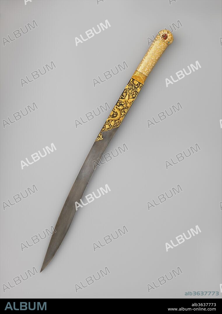 Short Sword (Yatagan) from the Court of Süleyman the Magnificent (reigned 1520-66). Culture: Turkish, Istanbul. Dimensions: L. 23 3/8 in. (59.3 cm); L. of blade 18 3/8 in. (46.7 cm); Wt. 1 lb. 8 oz. (691 g). Sword maker: Workshop of Ahmed Tekelü (possibly Iranian, active Istanbul, ca. 1520-30). Date: ca. 1525-30.
Exquisite workmanship and lavish use of precious materials distinguish this sword as a princely weapon and exemplifies the opulence and refinement of Ottoman luxury arts. Almost identical to a <i>yatagan</i> (now in the Topkapi Palace, Istanbul) made in 1526-27 by the court jeweler Ahmed Tekel, for the Ottoman sultan Süleyman the Magnificent (r. 1520-66), this sword was undoubtedly made in the same imperial workshop. The gold incrustation on the blade depicts a combat between a dragon and a phoenix against a background of foliate scrolls. These figures, like the gold-inlaid cloud bands and foliate scrolls on the ivory grips, are Chinese in inspiration, and were probably introduced into Ottoman art through contacts with Persia.
This sword is one of the earliest known <i>yatagans</i>, distinctly Turkish weapons characterized by a double-curved blade and a hilt without a guard. <i>Yatagans</i> were commonplace in Turkey and the Balkans in the eighteenth and nineteenth centuries and served as sidearms for the elite troops known as janissaries.