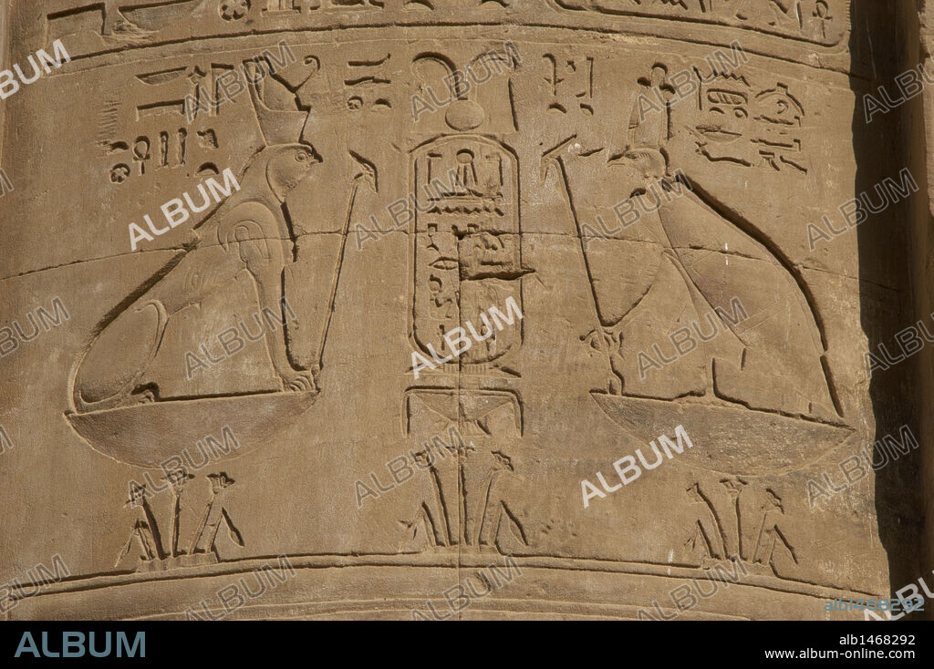 Egypt. Edfu. Temple of Horus. Relief depicting a sphinx with falcon head and double crown of lotus flowers and goddess Nekhbet with vulture form over lotus flowers.