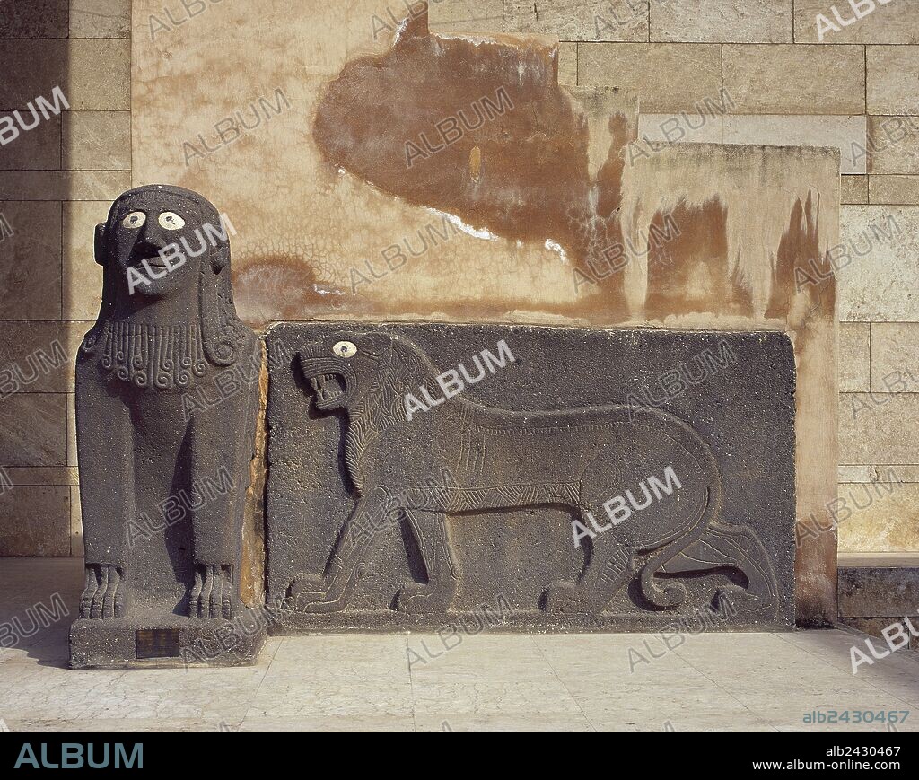 Sphinx and a lion in relief. Basalt. Guarding the temple of Tell Halaf. From about 6100 to 5400 b.C.. Currently located at the entrance to the National Museum of Aleppo. Syria.