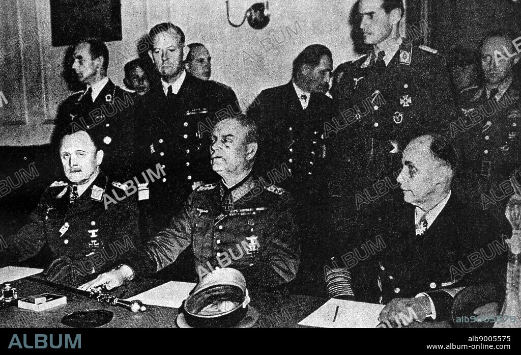 German services chiefs sign the surrender May 8, 1945. Above, L to R, P.F. Stumpf, appointed C.-in-C, the Luftwaffe Reich, Field-Marshal Wilhelm Keitel, Chief of the Supreme Command of the Wehrmacht; and Admiral Hans Georing von Friedeburg, C.inC. Pf the German Navy. Below Air Marshal Sir Arthur Tedder and Marshal Zhukov sign on behalf of the Allied Expeditionary Force and the Russian High Command respectively. On Sir Arthur's right is Mr V Vyshinsky, Soviet Vice-Commissar for Foreign affairs.