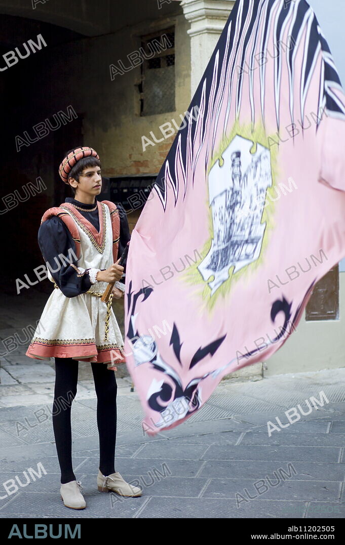 Contrada young man in livery costume at traditional parade in Asciano, inTuscany, Italy.
