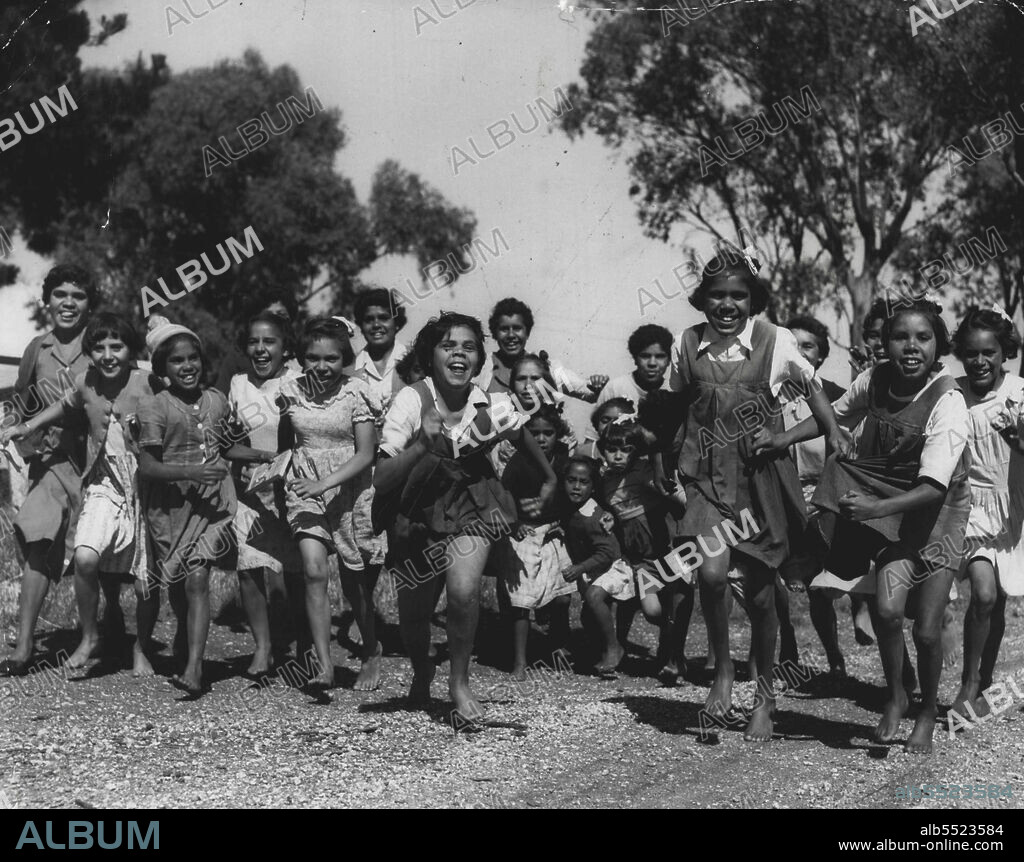 Cootamundra Aboriginal Girls' Home. A race to the dinner table. November 19, 1955. (Photo by Stuart William MacGladrie/Fairfax Media).