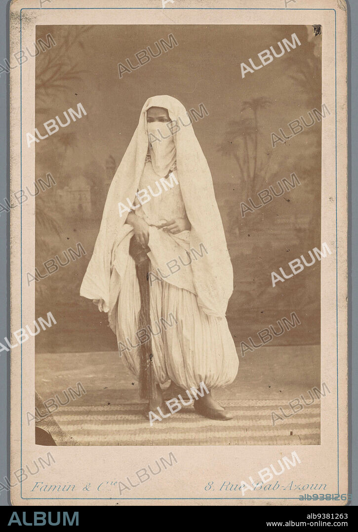 Algerian woman in harem pants and veil, Famin et Cie. (mentioned on object), Algerije, 1863 - 1889, cardboard, albumen print, height 164 mm × width 108 mm.