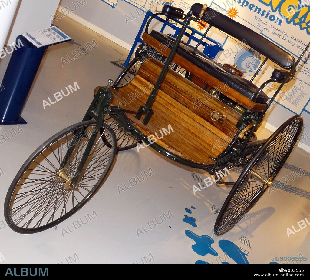 Replica of the world's first motor car which was built in 1886 by Karl Benz in Mannheim, Germany. It was powered by a single cylinder engine beneath the street.