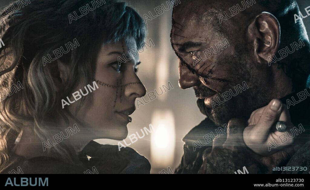 DAVE BAUTISTA and MILLA JOVOVICH in IN THE LOST LANDS, 2025, directed by PAUL W. S. ANDERSON. Copyright Constantin Film / Dream Bros. Entertainment.