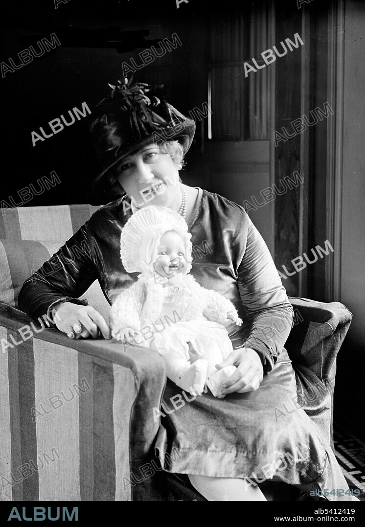 Beulah Louise Henry arrived at the Patent Office in Washington today to consult with Uncle Sam about one of her more than 40 inventions. Miss Henry is shown with her latest invention, an air baby doll which can be bathed and looks more like a real baby than any of its kind. Beulah Louise Henry (February 11, 1887 - February 1973) was an American inventor, given the nickname, Lady Edison. From a young age she loved to tinker with things and create newer objects with practical utility. The first of her numerous patents was for a vacuum ice cream freezer in 1912. Originally from North Carolina, she moved to New York City following the early successes of her inventions. One of her most popular early inventions was an umbrella with a snap-on cloth cover that allowed the owner to coordinate the umbrella with clothing. She worked as an inventor for the Nicholas Machine Works from 1939 to 1955. She also served as a consultant for many companies that manufactured her inventions, including the Mergenthaler Linotype Company and the International Doll Company. She lived in New York hotels, belonged to a variety of scientific societies, and never married. A very prolific inventor, she had around 110 inventions in total though she held the patent for only 49 during her lifetime. Henry was inducted into the National Inventors Hall of Fame in 2006. Photographed by Harris & Ewing, November 17, 1927.