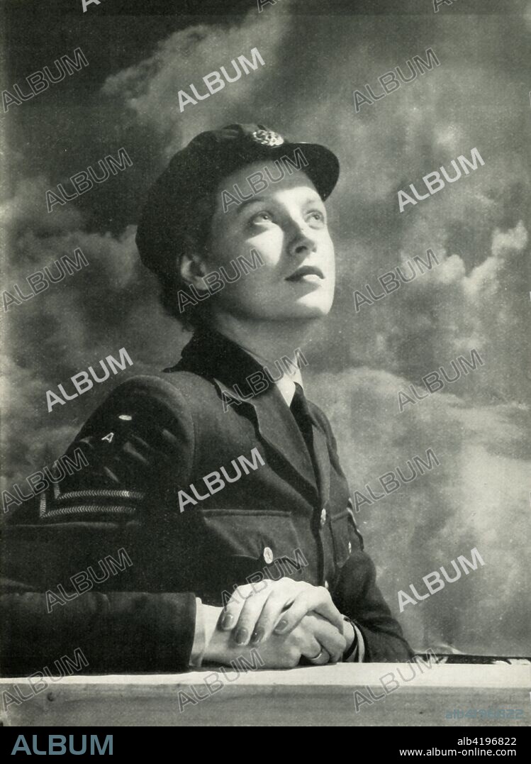 'Watching the Battle', c1943. WAAF watching a 'dogfight' between RAF and German air force planes. The Women's Auxiliary Air Force (WAAF), whose members were referred to as 'WAAFs', was the female auxiliary of the British Royal Air Force during World War II. Its members did not serve as aircrew, but although they did not participate in active combat, they were exposed to the same dangers as any on the home front working at military installations. Among their duties were: crewing of barrage balloons, catering, meteorology, radar, aircraft maintenance, transport, communications duties including wireless telephonic and telegraphic operation. At its peak strength, in 1943, the number of WAAFs (members of the force) exceeded 180,000, with over 2,000 women enlisting per week. From "Wings On Her Shoulders", by Katharine Bentley Beauman, Late Fight Officer W.A.A.F. [Hutchinson & Co Ltd, London, New York, Melbourne, c1943].