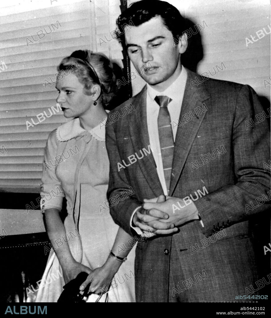 No Divorce 90 Days -- Edmund Purdom, British film star, walks past his estranged wife, Tita, outside a Superior courtroom today where attempts were renewed to reconcile them. Purdom, whose name has been linked with Linda Christian's, agreed to suspend his divorce action against his wife for 90 days. Miss Christian today sued her husband. Tyrone Power, for divorce. April 19, 1955. (Photo by AP Wirephoto).
