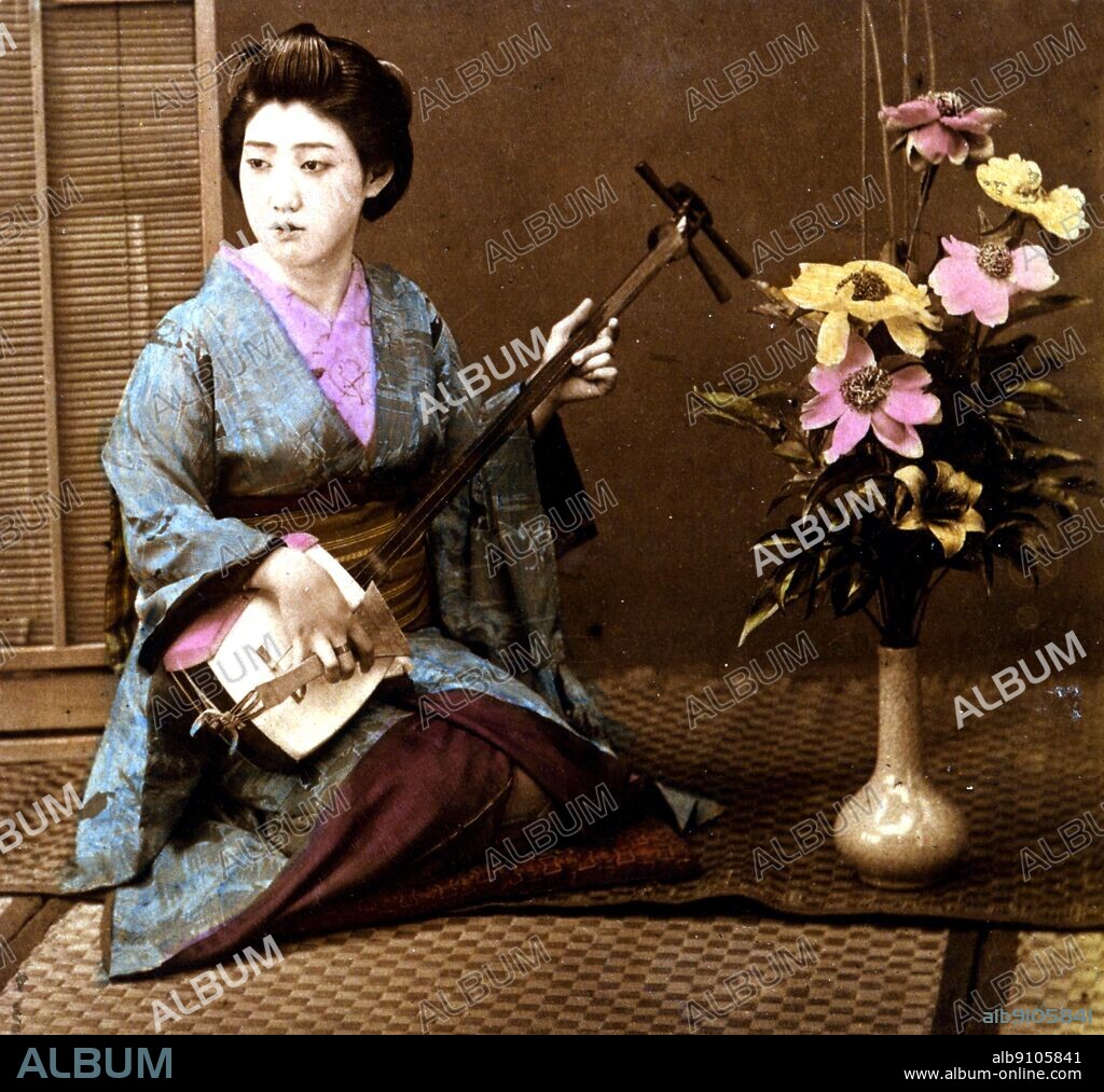 A geisha playing a shamisen (or samisen). Tokyo, 1898.