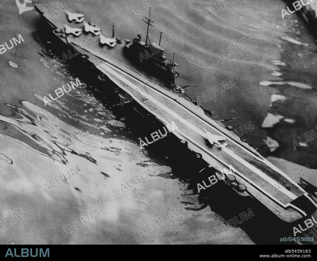 New Flight Deck Arrangement For Aircraft Carriers - The new type of angled flight deck.With the object of increasing the fighting power of the aircraft carrier, a new flight deck arrangement has been devised by the Royal Navy and the Ministry of supply.The idea is being developed simultaneously both in the United States and the United kingdom. Known as the "Angled Deck", the concept is extremely simple and results from a basically new approach to the problem of flying aircraft on to ships. Broadly speaking it involves the laying out of the flight deck and modifying slightly its conventional shape so that aircraft fly on at an angle of about eight degrees. November 14, 1952. (Photo by British Official Photograph).