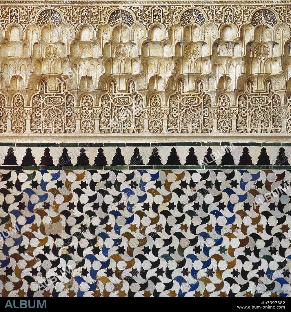 Granada. Alhambra. Nasrid dynasty. Wall decorated with arabesques, calligraphy and tessellation tiles. Andalusia, Spain. 13th century.