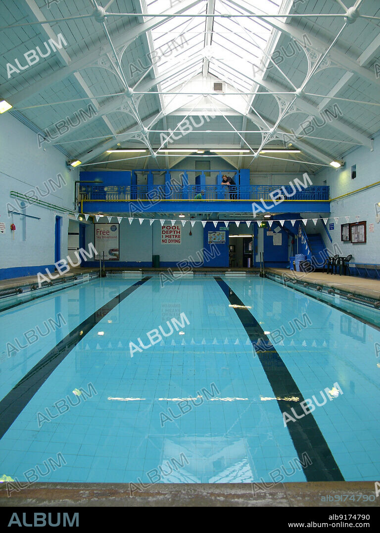 SIMON INGLIS. Woolton Baths, Quarry Street South, Woolton, Liverpool, 2006. The swimming pool in the Woolton Baths, also known as Woolton Swimming Pool. The Woolton Baths, later known as the Woolton Swimming Pool, opened in 1893. The building was designed by the Manchester architects Horton & Bridgford, and funded by Holbrook Gaskell, a local philanthropist and chemical manufacturer. The Woolton Baths closed to the public in 2010 and a campaign began to raise funds for repairs and restoration. They are a rare example of a small, late 19th century village swimming baths and are Grade II Listed.