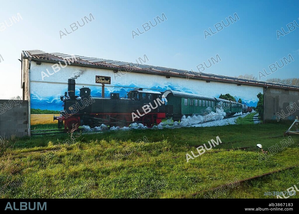 Mural of an old steam locomotive on a warehouse at Rehna Station, Rehna, Mecklenburg-Western Pomerania, Germany, Europe *** IMPORTANT: For editorial use only ***.