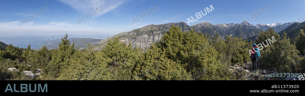 A woman trekking in the Taygetos mountains on the Mani Peninsula in the Peloponnese, Greece, Europe.