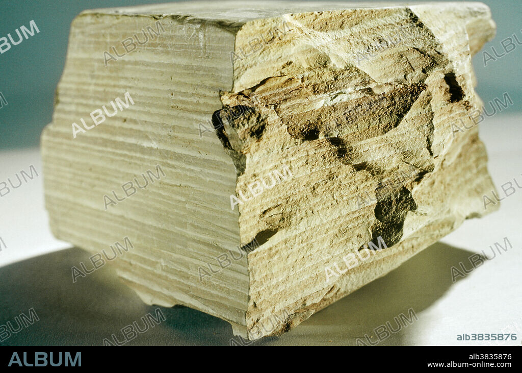Sedimentary rocks are created when particles are laid down in layers by wind or water, and then compacted or cemented together. Some of the finest particles in geologic environments are clay minerals, which have the form of microscopic plates that can be packed solidly into dense layers. Clay deposition, especially in lakes, is often related to seasonal events (such as melting snows) that affect the volume of flowing water and therefore the amount of sediment that can be carried. These annual changes are sometimes preserved in hardened clay beds (claystone) in the form of light and dark bands, known as varves.