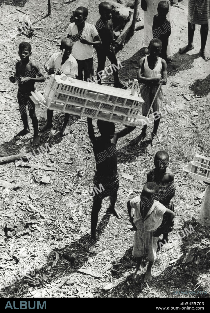 Life On The Congo River -- The tenth Gatti African Expedition goes up the Congo River from Leopoldville to Stanleyville.
At each stop of the boat the travelers were received by droves of natives who offered them their wares. These boat models carved out of wood cost three francs apiece. February 06, 1943. (Photo by Attilio Gatti-Pix).
