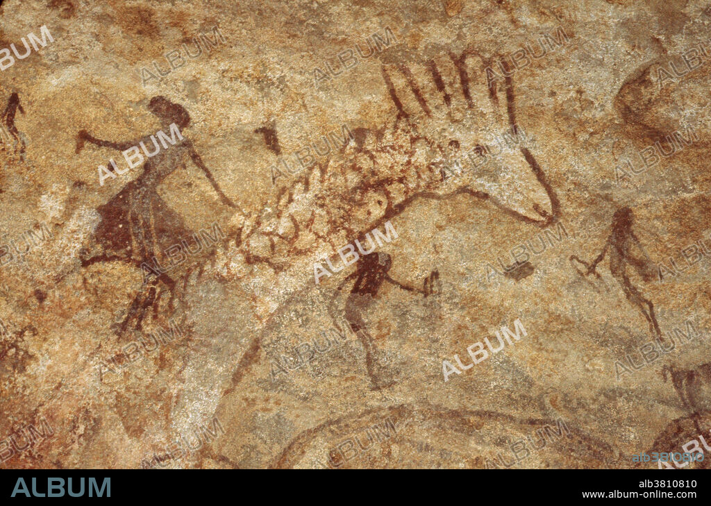 Prehistoric painting depicting hunters and a giraffe, Tassili n'Ajjer plateau, South Algeria.