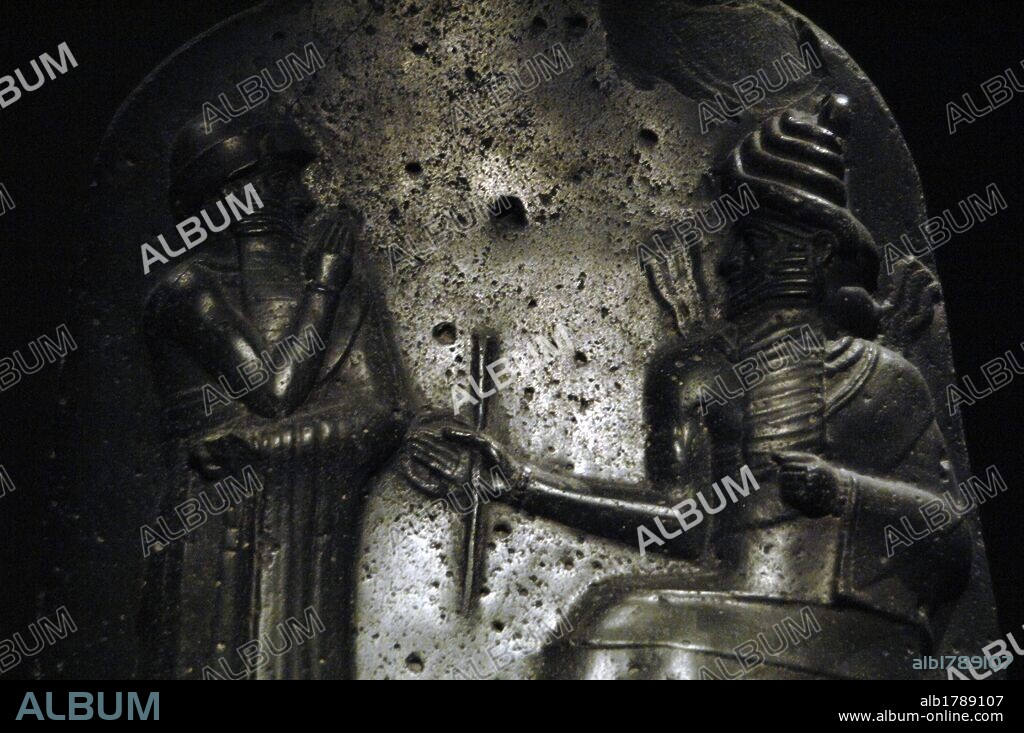 Law Code of Hammurabi, king of Babylon. Basalt stele, erected by King Hammurabi of Babylon (1792-1750 BC). Detail of the relief depicting Hammurabi (standing) receiving his investiture from Shamash, god of justice. Louvre Museum. Paris, France.