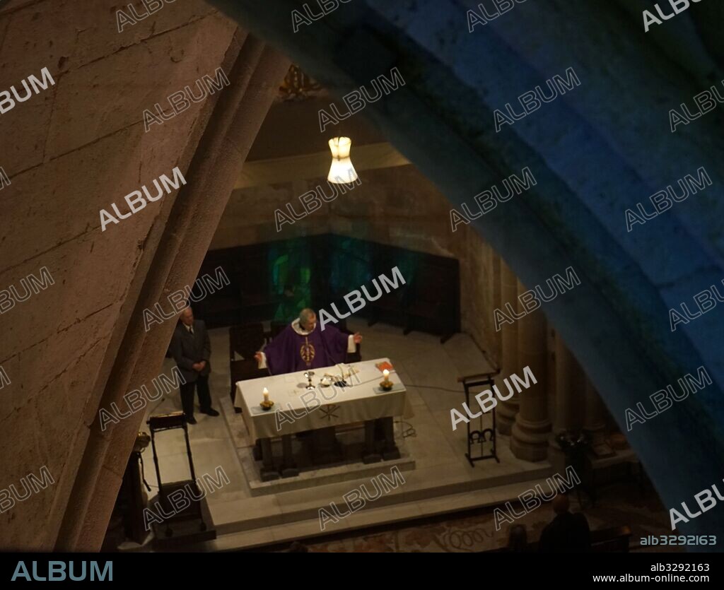 Catholic mass held in the crypt of the Sagrada Familia, Catholic church in Barcelona, designed by Spanish architect Antoni Gaudi (1852–1926).
