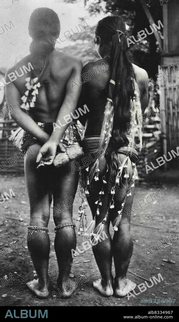 "Tarzans" Of The Philippines -- The physical characteristics of the Ibilao tree men are unlike that associated with the Tarzans of fiction. Their symmetrical body lines make them seem almost feminine and this is further borne out the long hair which is dressed and decorated with white horsehair as shown in the above photograph. February 17, 1939. (Photo by Aleko E. Lilius, Wide World Photos).