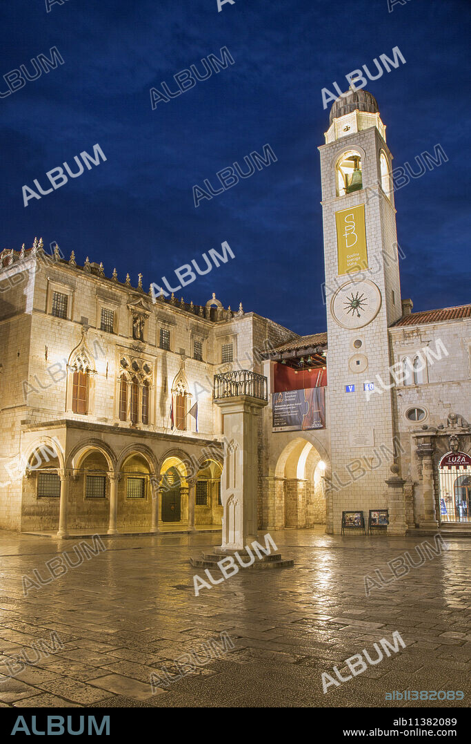 View across marble-paved Luza Square to the Sponza Palace and clock tower, dusk, Dubrovnik, Dubrovnik-Neretva, Dalmatia, Croatia, Europe.