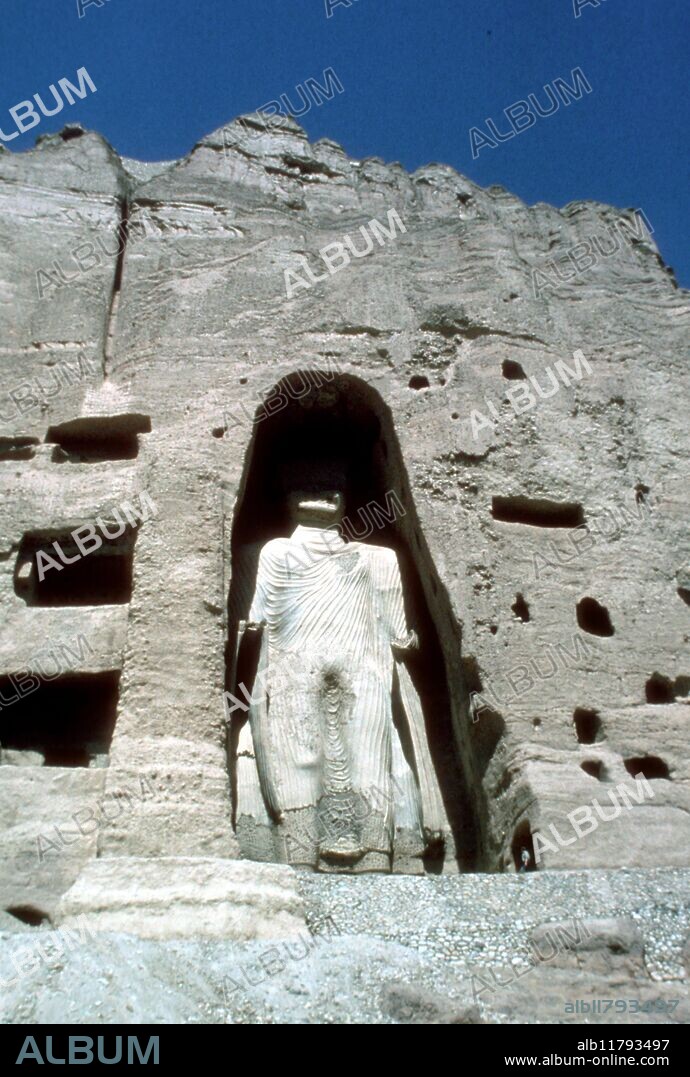 The Bamiyan Valley of Khohistan, Afghanistan: statue of Buddha 55 metres tall, now destroyed. Bamyan was the site of an early Buddhist monastery. Many statues of Buddha are carved into the sides of cliffs facing Bamyan city. The two most prominent of these statues were standing Buddhas, now known as the Buddhas of Bamyan, measuring 55 and 37 meters high respectively, that were the largest examples of standing Buddha carvings in the world. They were probably erected in the 4th or 5th century C.E. They were cultural landmarks for many years and are listed among UNESCO's World Heritage Sites. In March 2001 the Taliban government decreed that the statues were idolatrous and ordered them to be demolished with anti-aircraft artillery and explosives. ©TopFoto / Fortean *** Local Caption ***.