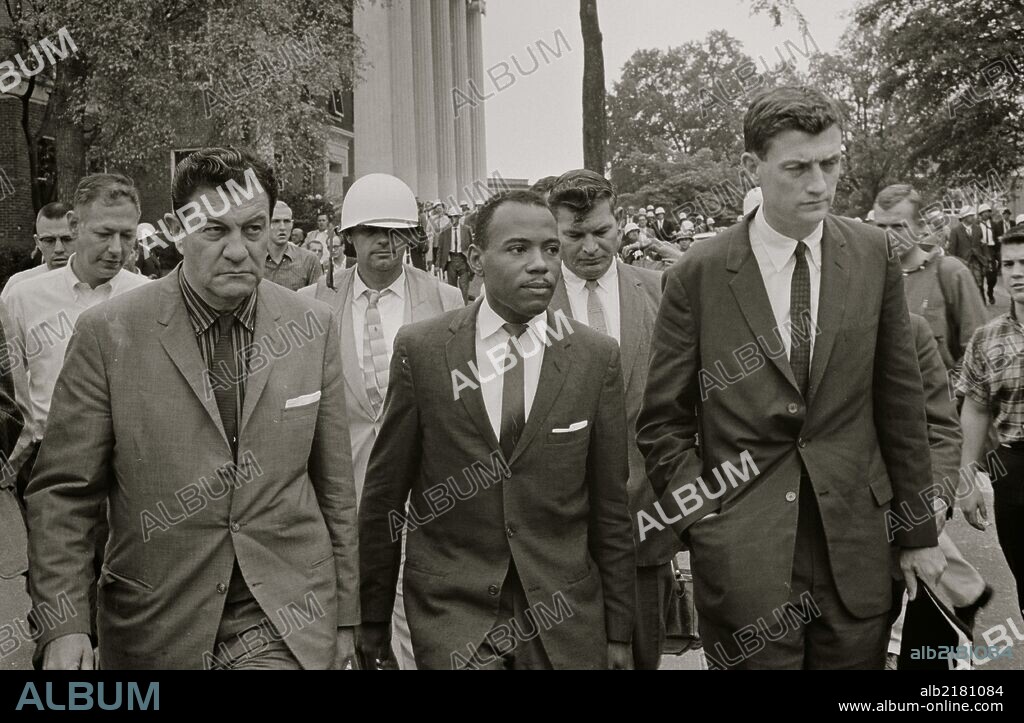 James Meredith walking to class accompanied by U.S. marshals.