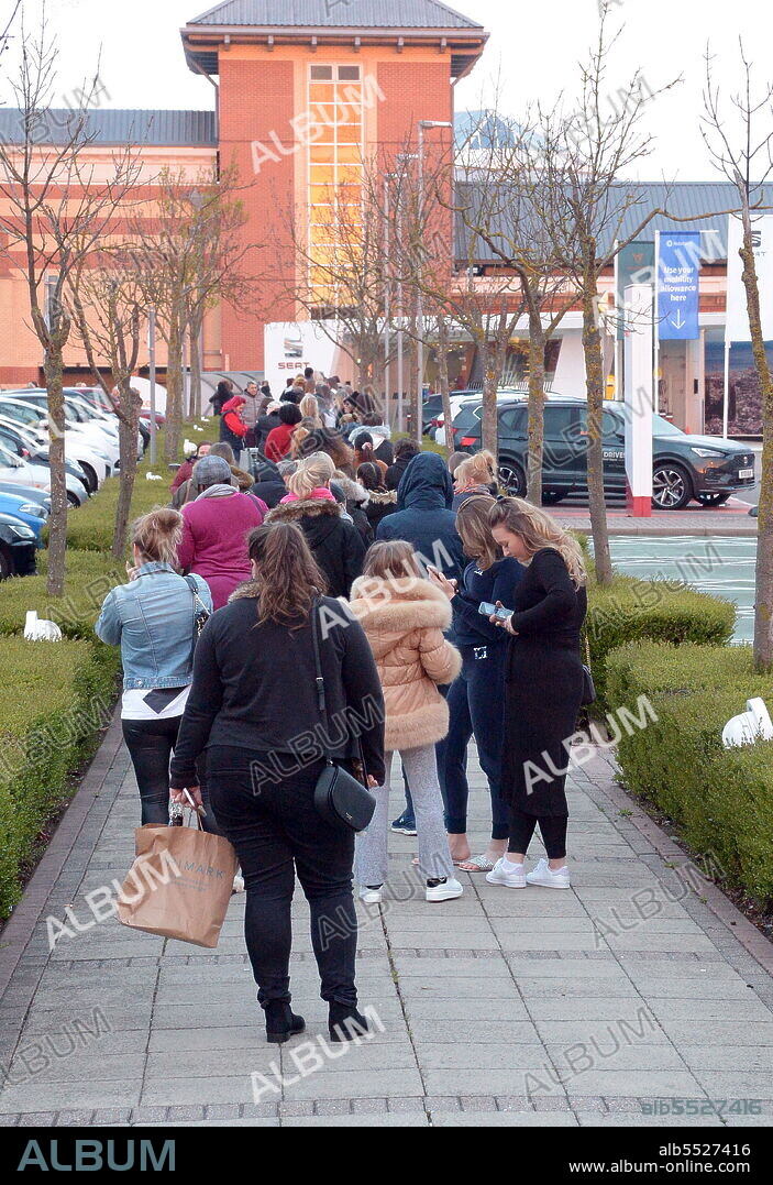 People queue outside Primark at Lakeside Shopping Centre in Thurrock, Essex at 6 a.m. as shops open as rules are relaxed during a third national lockdown in England amid the COVID-19 coronavirus pandemic. 12th April 2021.