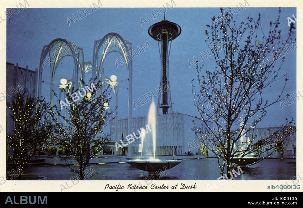 Pacific Science Center at dusk, Seattle, Washington, USA, 1963. Vintage postcard showing an evening view of the Pacific Science Center. Lighted trees, fountains, pools and arches are in the plaza in front of the buildings. The Pacific Science Center and the 184 metre high Space Needle form part of the Seattle Center, built for the 1962 World's Fair staged in the city.
