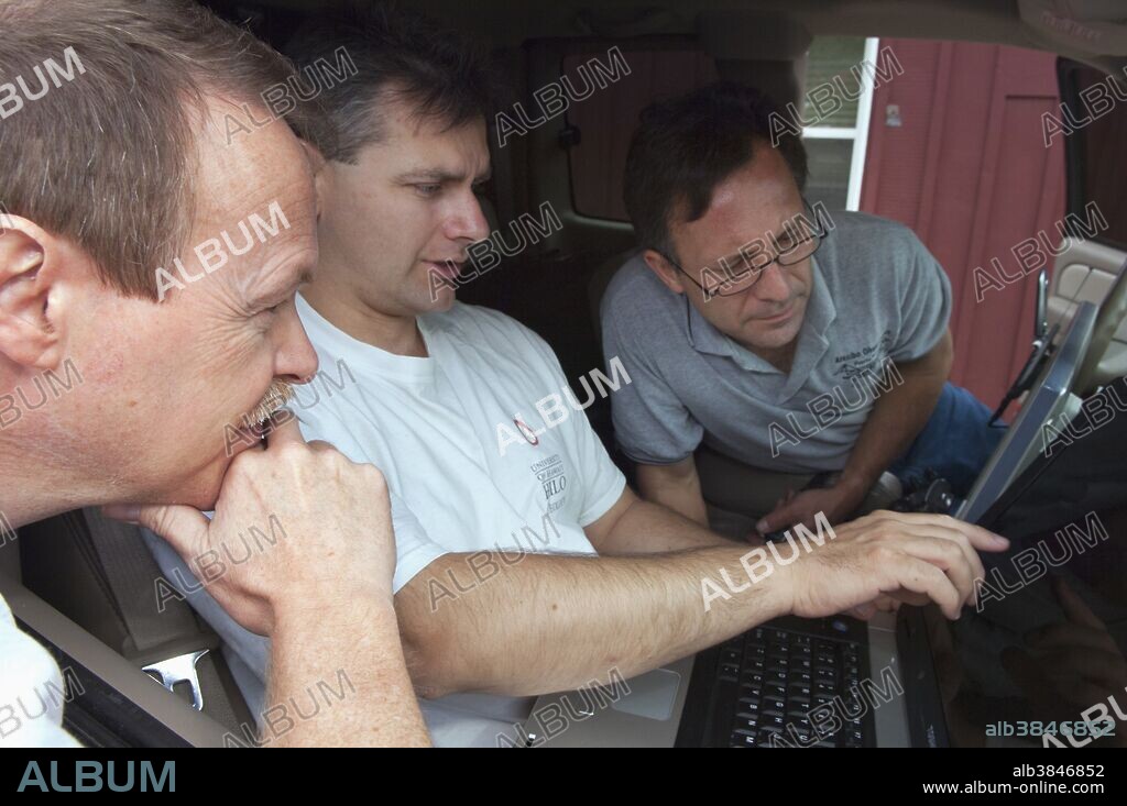 Veteran storm chaser Tim Samaras, far right, monitors the weather from his chase vehicle with colleagues Carl Young (center) and Jon Davies in 2005. Samaras, an esteemed scientist and noted tornado researcher, died with his son Paul and longtime chase partner Young while intercepting a violent twister near El Reno, Oklahoma on May 31, 2013. Samaras and Young were also known from the Discovery Channel show "Storm Chasers," which aired for five years.