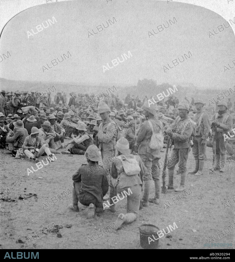 The overpowered Boer prisoners resting on the road from Paardeberg to Modder River, 1900. General Piet Cronje's men, captured by the British at the Battle of Paardeberg. Stereoscopic card.