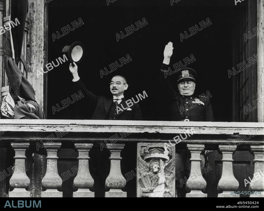 Salute From Palazzo Venezia - Japanese Foreign Minister Yosuke Matsuoka (left) waves his silk hat and premier Benito Mussolini of Italy, gives the fascist salute from balcony of the Palazzo Venezia during Matsuoka's visit to Rome on April 1. April 15, 1941. (Photo by Associated Press Photo).