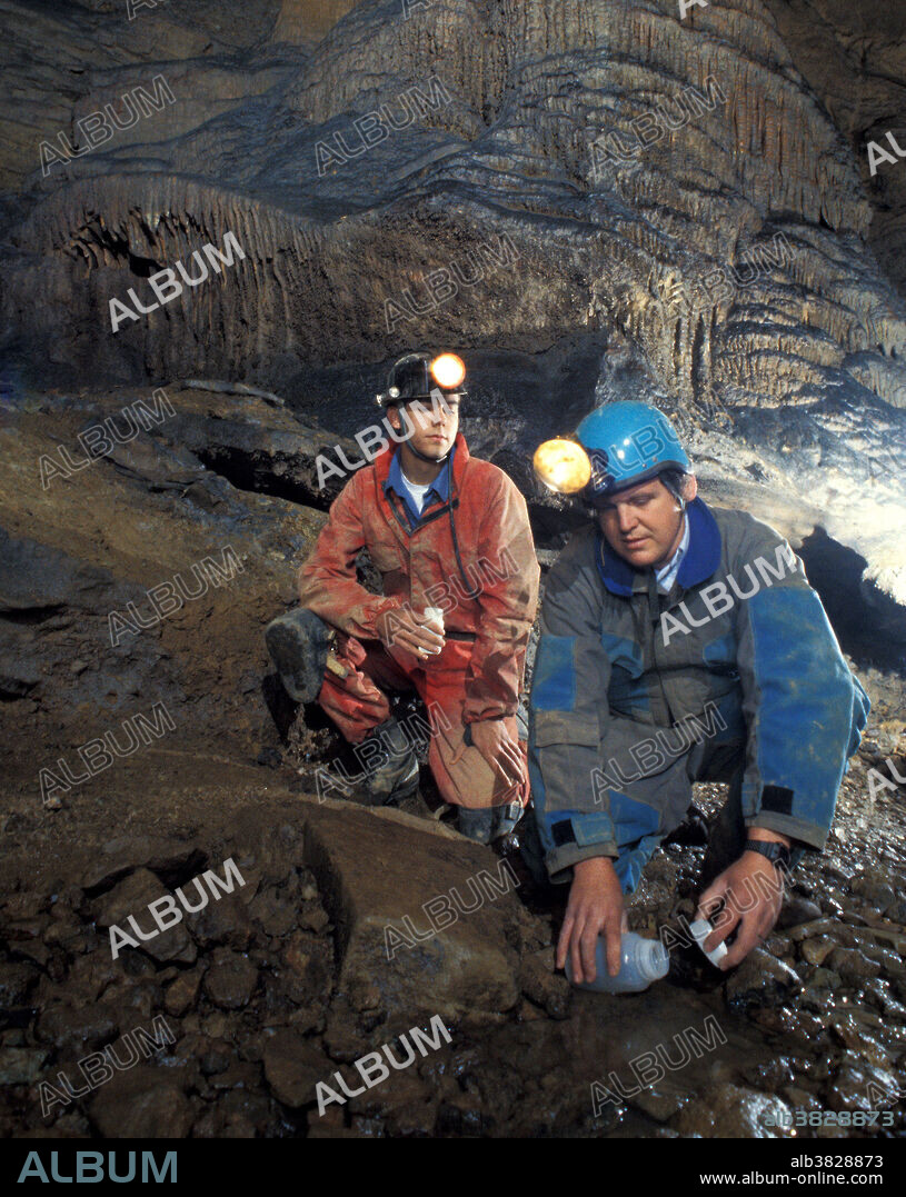ARS hydrologist Doug Boyer (right) and aide Derek Hall collect water samples from a stream in a West Virginia limestone cave. The calcite formation in the background is The Haystack in McClungs Cave.