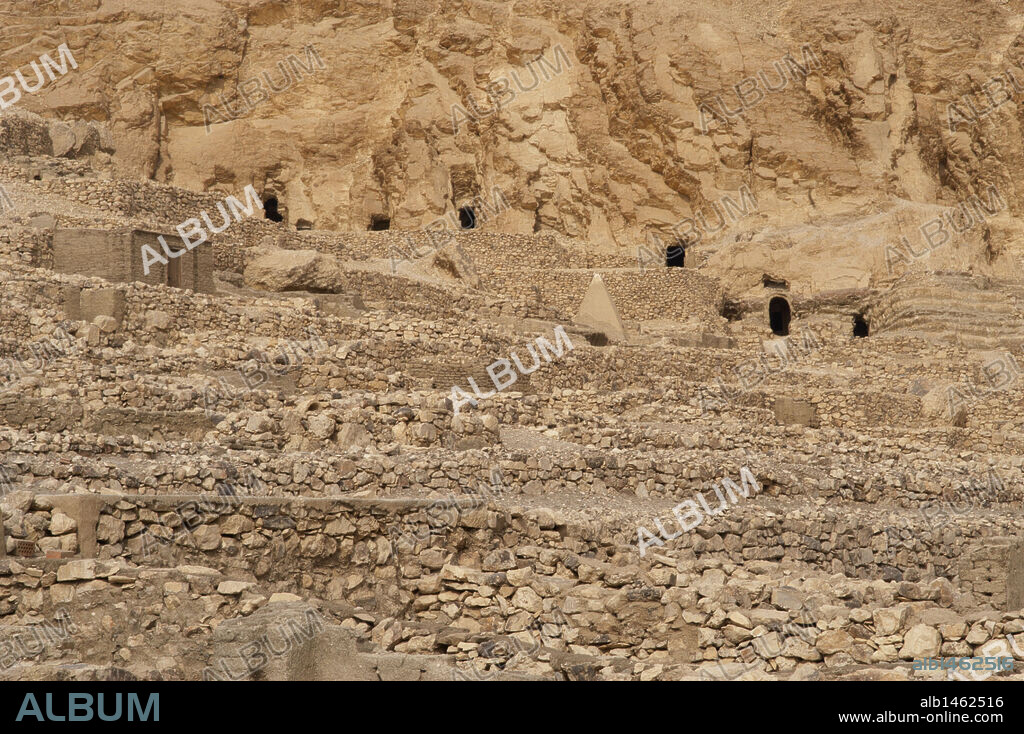 Valley of the Artisans. Ruins of Set Maat's settlement, home to the artisans who worked on the tombs in the Valley of the Kings during the 18th to 20th dynasties. Tombs in the necropolis of the village in the background. New Kingdom. Deir el-Medina. Egypt.