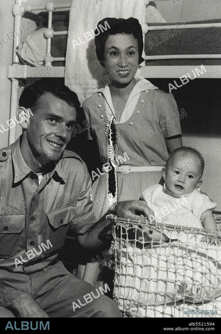 Sgt. Don Parsons of Victoria with his Jap wife Julie age 24 & baby Helen Elizabeth. In this cabin aboard the new Australia coming down the coast of N.S.W. April 10, 1953.