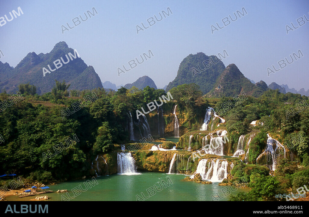 Ban Gioc Detian Falls are 2 waterfalls on the Quay Son River or Guichun River straddling the Sino-Vietnamese border, located in the Karst hills of Daxin County in the Chongzuo prefecture-level city of Guangxi Province, on the Chinese side, and in the district of Trung Khanh District, Cao Bang province on the Vietnamese side, 272 km north of Hanoi. Guangxi, formerly romanized Kwangsi, is a province of southern China along its border with Vietnam. In 1958, it became the Guangxi Zhuang Autonomous Region of the People's Republic of China, a region with special privileges created specifically for the Zhuang people.