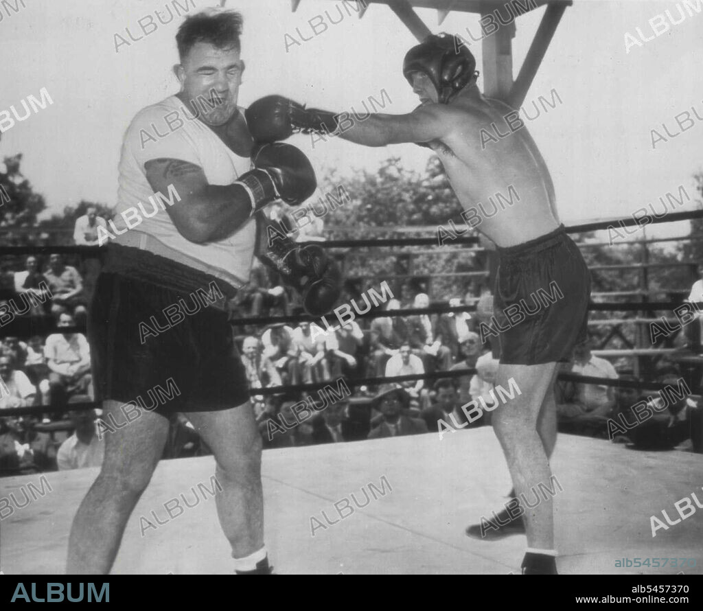 Conn Shoots A Left - Billy Conn (right) bounces a straight left off the jaw of sparring mate Mickey McAvoy during training session at his camp yesterday as he gets ready for his 15-round heavyweight title bout in New York city June 19 against Joe Louis. June 13, 1946. (Photo by AP Wirephoto).