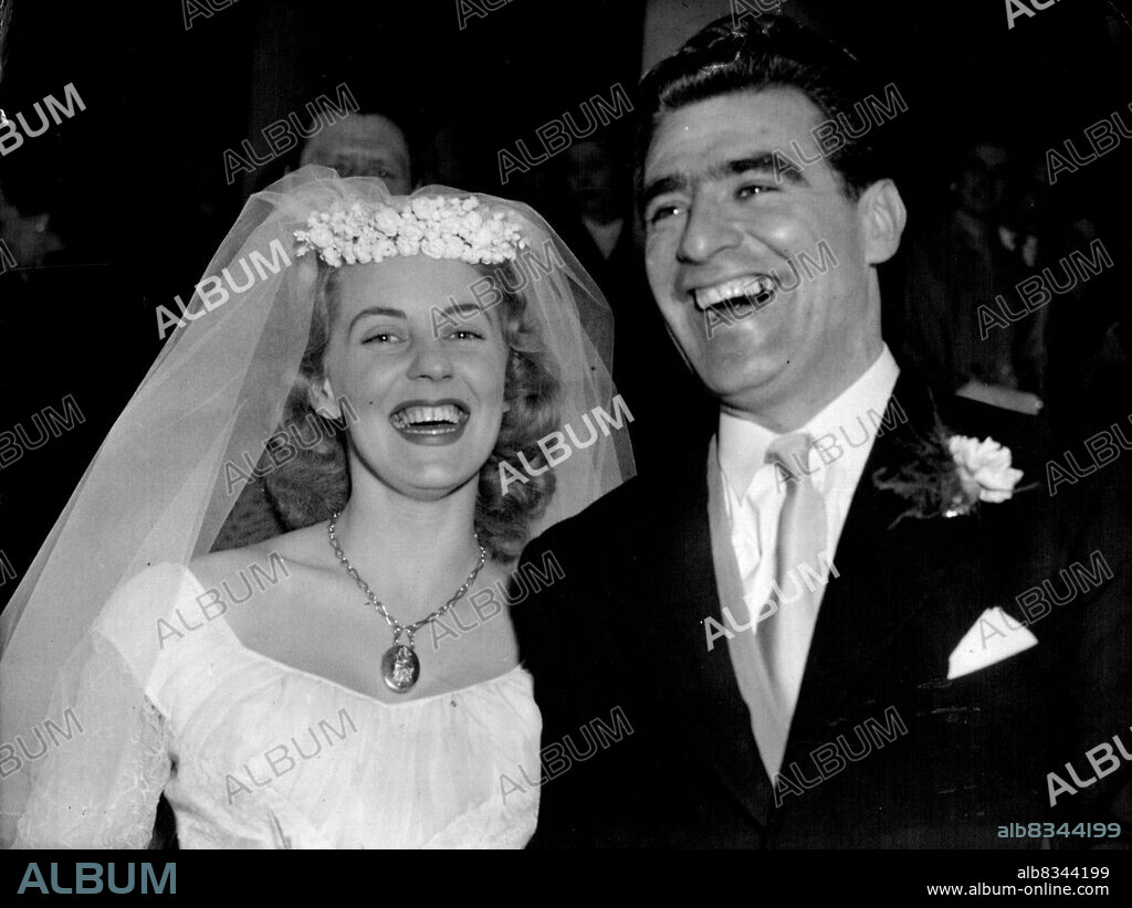 Champion Cyclist Weds:World Champion Sprint Cyclist Sidney Patterson, of Sydney, Australia, seen with his bride, the former Miss Jo-Ellen Ann Davis after their Easter Sunday wedding at St. Mary-Le-Strand, London. April 10, 1955. (Photo by Associated Press Photo).