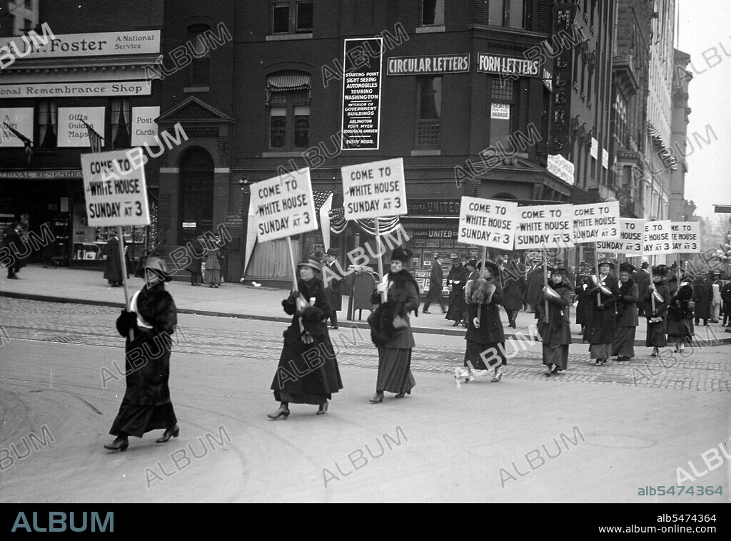 Woman suffragettes marching through the streets carrying signs inviting others to join them at the White House circa 1917.