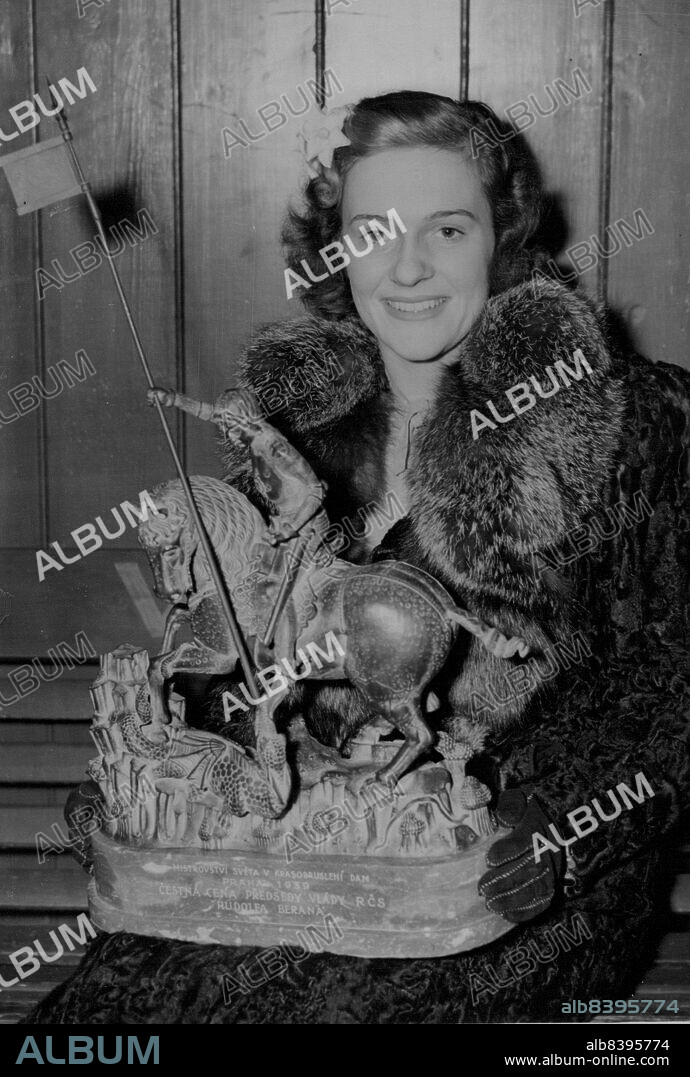 Queen of The Ice Returns To England After Her Triumph In Prague -- Miss Megan Taylor, the Famous British Skater, on her Arrival in London today Feb. 16. She is holding the Trophy she won in Prague as the World's Figure Skating Champion. The Trophy is a Replica of the most Famous Statue in Czechoslovakia.Miss Megan Taylor, the Well-known British Skater, who won the World's Figure-Skating Championship at Prague last Week-end, Returned to London after her Triumph, today Feb. 16. Owing to the Absence of Miss Cecilia Colledge, who was unable to compete owing to a strained Tendon, Miss Megan Taylor, won the Title Easily. February 16, 1939. (Photo by Associated Press Photo).