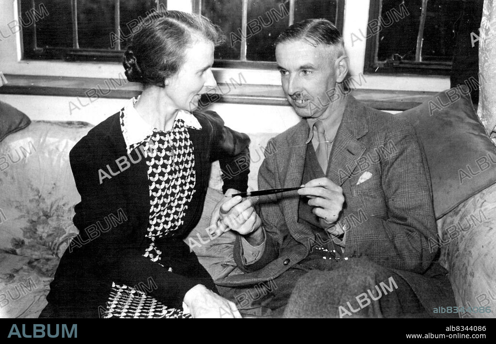 General Percival Back In England - Singapore Commander Rests at Hertfordshire After Secret Arrival -- General Percival with his wife the fountain pen given to him by General MacArthur, at his home in Hertfordshire.Lieutenant General Arthur Ernest Percival CB; DSO; OBE; MC. British commander at the fall of Singapore, has arrived secretly in this country after his release from 3½ years captivity in a Japanese prison camp in Manchuria, and is now resting with his wife and children at his home in Hertfordshire. September 12, 1945.