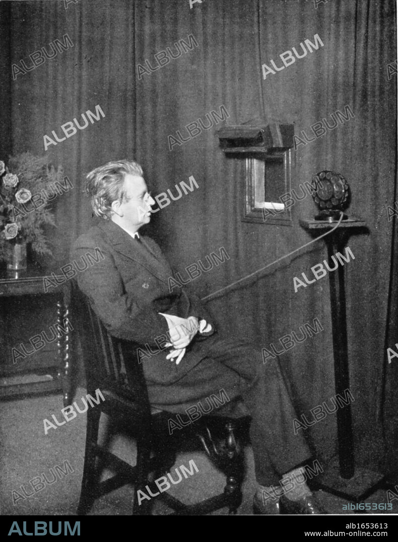 John Logie Baird (1888-1946) Scottish electrical engineer: pioneer of television. Baird giving early television ('Seeing by wireless') demonstration: image is of someone holding two dolls.