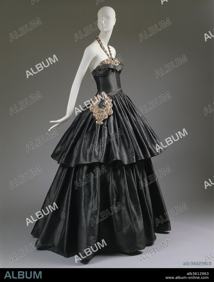"Cyclone". Culture: French. Design House: House of Lanvin (French, founded 1889). Designer: Jeanne Lanvin (French, 1867-1946). Date: 1939.
This gown is part of a collection assembled and brought to New York by Mrs. Ector Munn and Mrs. Harrison Williams who, among others, chaired the American branch of the WWII French war charity, "Le Colis de Trianon-Versailles." In 1940, with the support of Lady Mendl and the Duchess of Windsor, they organized an exhibition, "Paris Openings," to raise money.  The exhibition, which was held at the John Wanamaker Auditorium in New York, featured evening dresses of the women of society and were chosen either for their "hallowed memory," or if they had been worn on some "Great Occasion." They all revealed the supreme and unsurpassed craftsmanship of the couture métier in the five years leading up to World War II.  
This "Cyclone" evening dress by Jeanne Lanvin was worn by her daughter the Comtesse Jean de Polignac. According to Bettina Ballard, she was a "soft beauty" who belonged more to the intimacy of the private salon than to public places of entertainment. This spectacular creation of Lanvin's was featured in the 2002-2003 exhibition "Blithe Spirit: The Windsor Set," and had not been shown in New York since its debut in 1940.