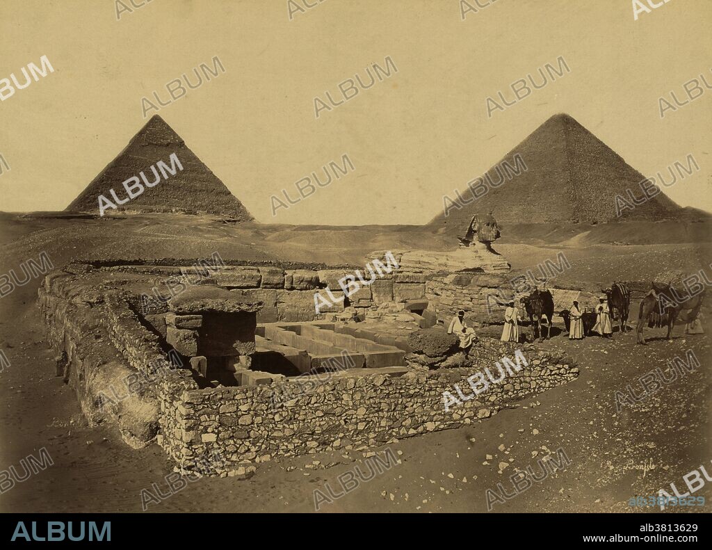 Entitles: "Pyramides de ChÃ©ops et de Cheffren, le sphynx, et la temple de Cheffren (Pyramids of Cheops and Cheffren, the sphynx, and the temple of Cheffren). The Giza Necropolis (pyramids of Giza) is an archeological site on the Giza Plateau, on the outskirts of Cairo, Egypt. This complex of ancient monuments includes the three pyramid complexes known as the Great Pyramids, the massive sculpture known as the Great Sphinx, several cemeteries, a workers' village and an industrial complex. The pyramids, which have historically loomed large as emblems of ancient Egypt in the Western imagination, were popularized in Hellenistic times, when the Great Pyramid was listed by Antipater of Sidon as one of the Seven Wonders of the World. It is by far the oldest of the ancient Wonders and the only one still in existence. The Great Sphinx of Giza is a limestone statue of a reclining sphinx (a mythical creature with a lion's body and a human head) that stands on the west bank of the Nile. It is the largest monolith statue in the world, standing 241 feet long, 63 feet wide, 66 feet high. It is the oldest known monumental sculpture, and is commonly believed to have been built by ancient Egyptians of the Old Kingdom during the reign of the Pharaoh Khafra (2558-2532 BC). Photographed by Maison Bonfils, circa 1867 and 1899.