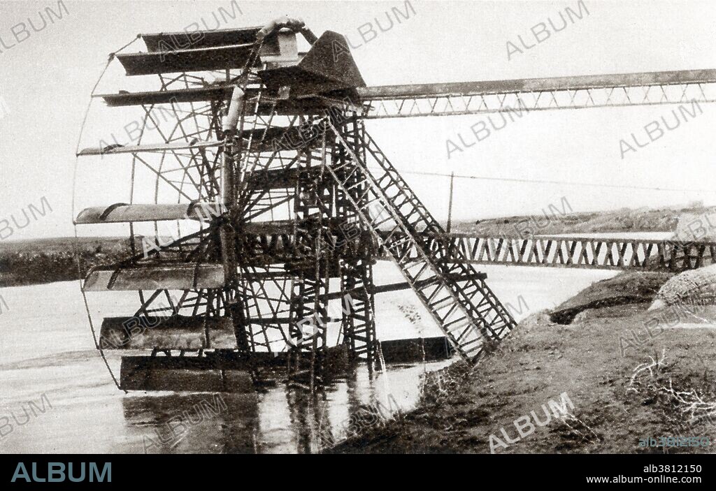 A noria from the 1930s, in a Khabur River settlement in Syria. A noria is a device for lifting water into a small aqueduct, usually for irrigation. This waterwheel's rim is made up of a series of containers which lift water from the river to the aqueduct at the top of the wheel. Compare with an older noria in BX1060.