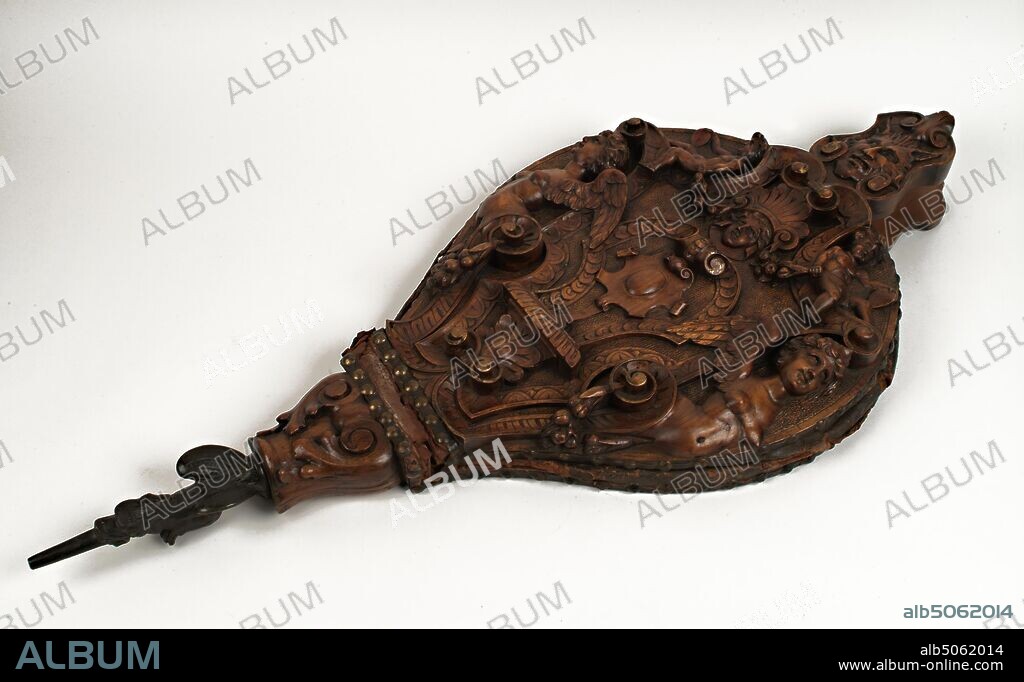 Bellows, 1500-1600 Pair of Italian, ornately carved walnut and bronze bellows, made in the sixteenth century. Bellows were needed to pump air into the embers to coax the fire to life. Most of them were plain and ordinary objects. However, some bellows, especially from Italy and France were elaborately carved by master craftsmen. The deeply carved winged figures, together with the grotesque carvings of the satyr's head on the bellow's handles, were popular features on carvings in the second half of the 16th century. Social history, Wood.