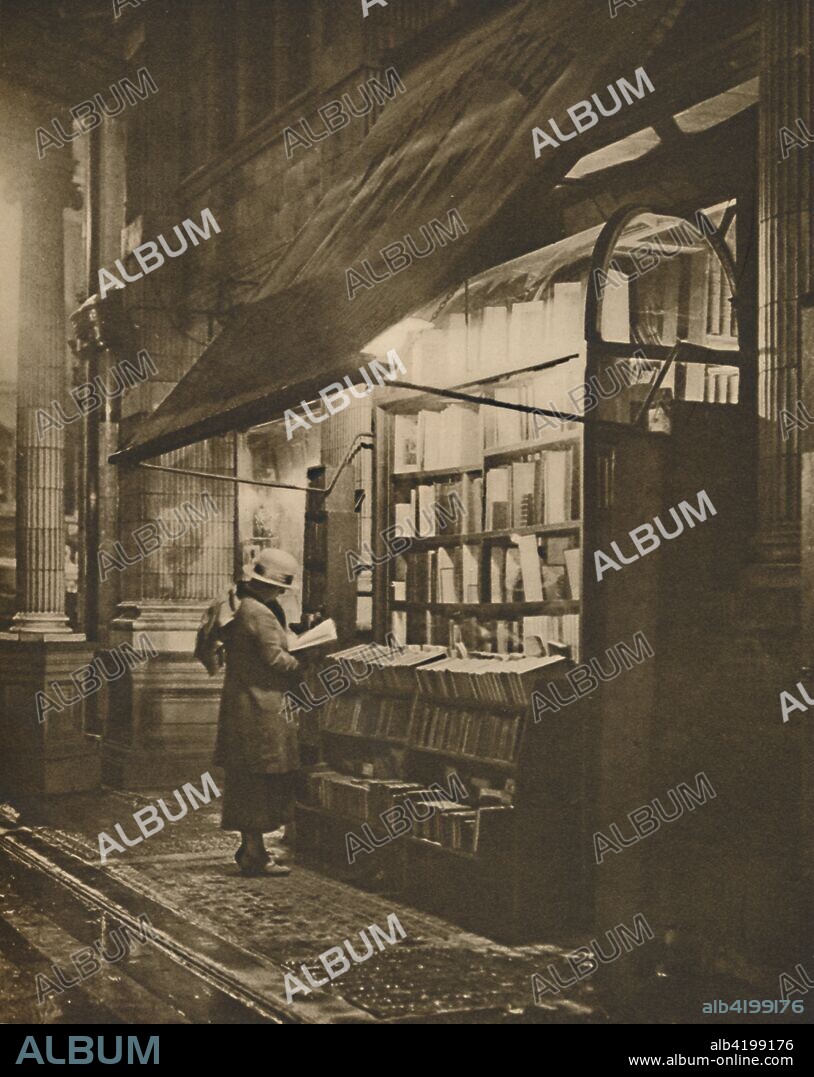 'Wet Winter Evening and a Book Lover in Bloomsbury', c1935. Shelves of books outside a shop in central London. From "Wonderful London, Volume 2", edited by Arthur St John Adcock. [The Fleetway House, London, c1935].