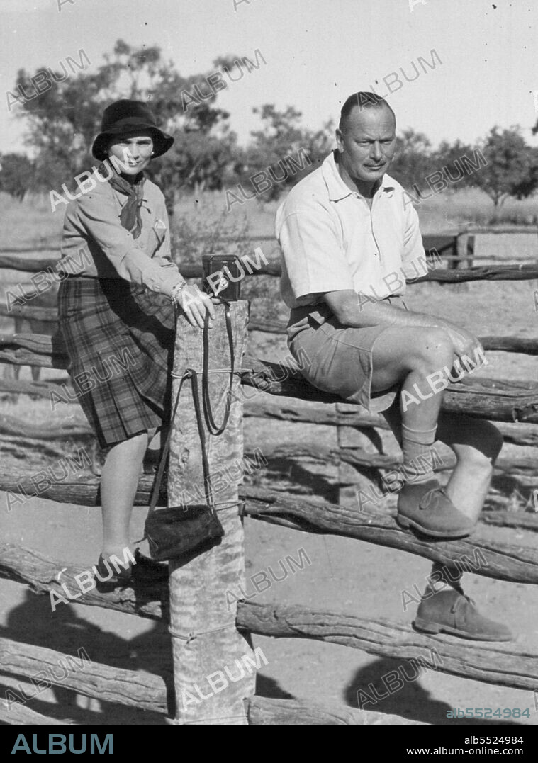 The Duke and Duchess sit astride the stock rails to watch the branding on Augustus Down's station. July 04, 1948.