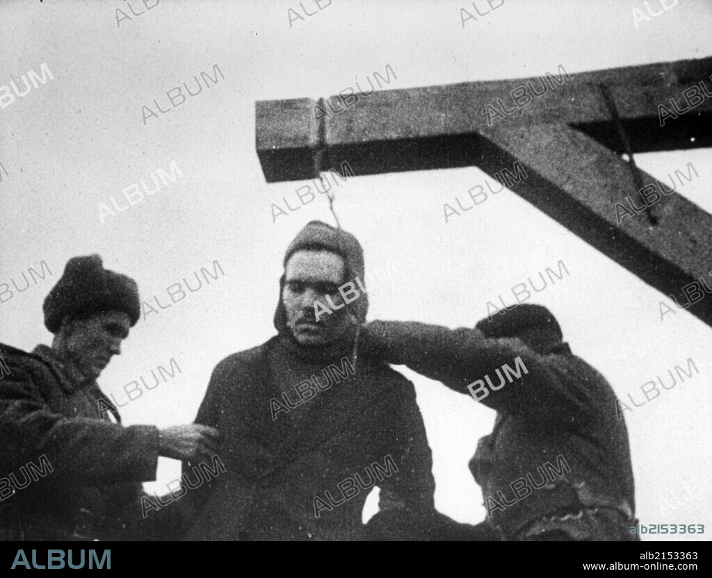 World war 2, december 19, 1943, still from a film on the kharkov trial produced by artkino, noose being placed around the neck of the russian traitor, mikhail petrovich bulanov.