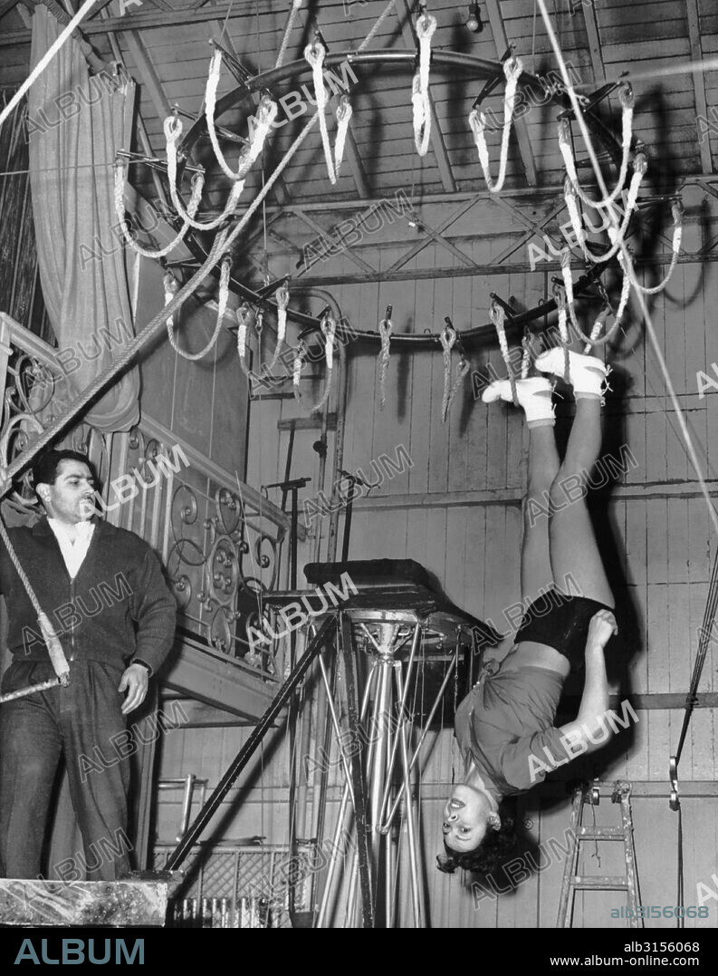 Paris, France:  January 26, 1954 Actress Cora Camoin rehearses a number she will present at the annual French Theater Benefit Show. She will perform walking on the ceiling with loops of rope thirty feet up in the air.